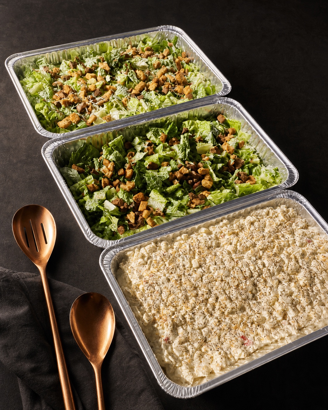 Prepared salads and a creamy side dish for an event